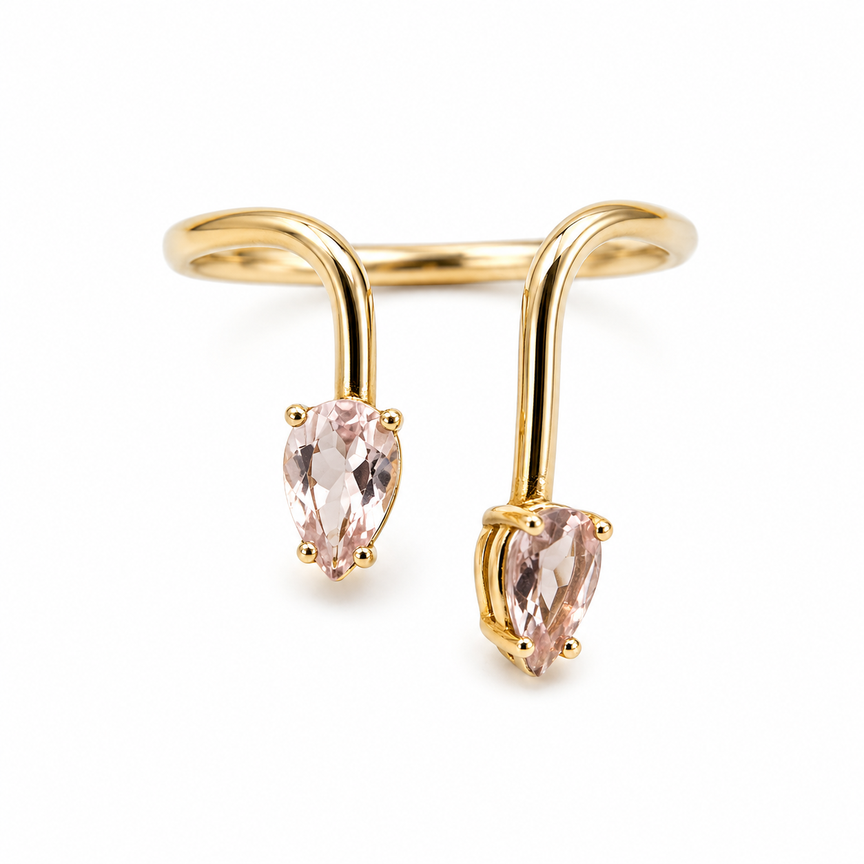 Gold ear cuff with pink gemstones on a white background