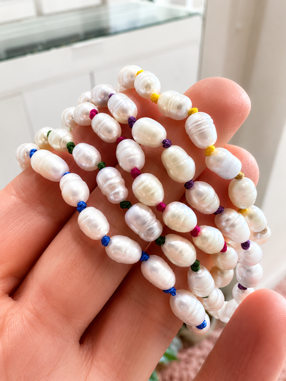 Pearl bracelet with red beads on a white background