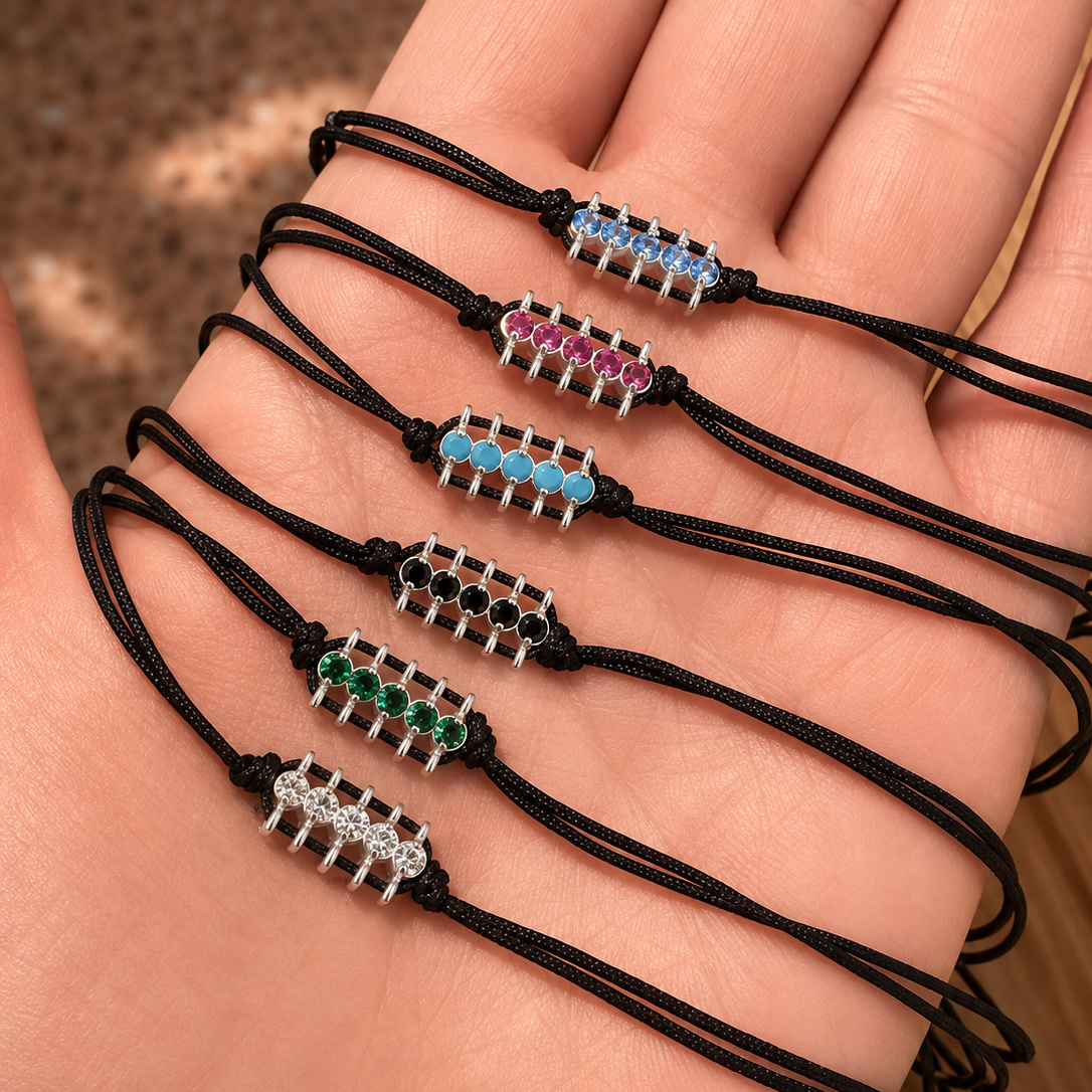 Set of black cord bracelets with colorful beads on a hand