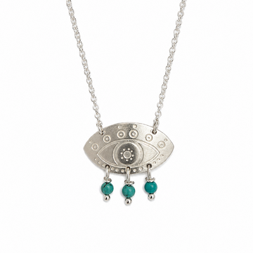 Silver necklace with an eye-shaped pendant and turquoise beads on a white background