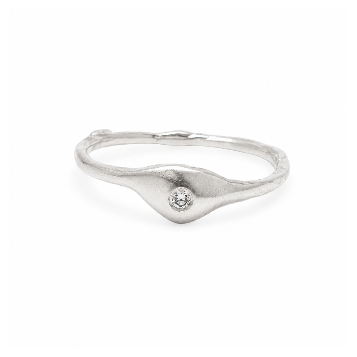 Silver ring with a small diamond on a white background