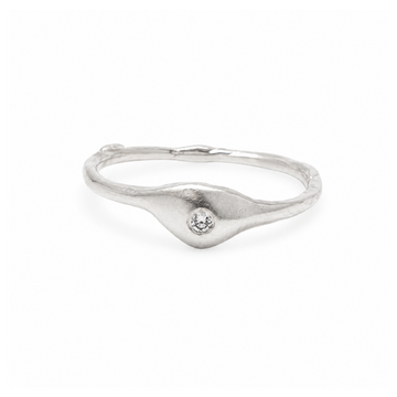Silver ring with a small diamond on a white background
