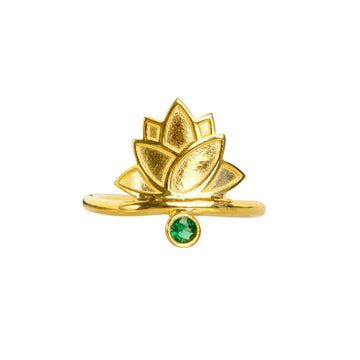 A gold-colored lotus flower ring with a green gemstone at its center, set against a white background.