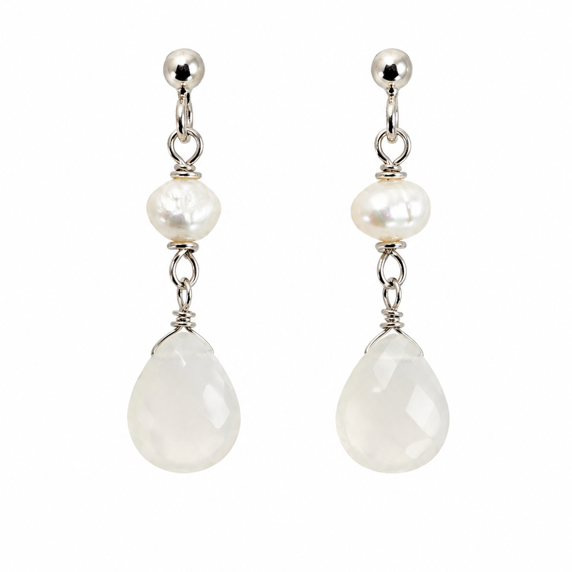 A pair of silver drop earrings featuring a small white pearl, a faceted white teardrop stone, and polished silver posts, shown against a plain white background.