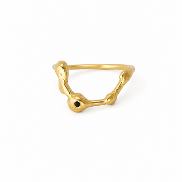 Gold ring with a black gemstone on a white background