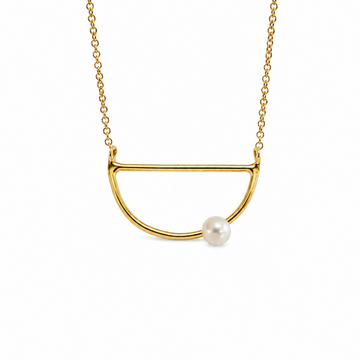 A gold necklace featuring a minimalist semi-circular open pendant with a single white pearl accent, shown against a plain white background.