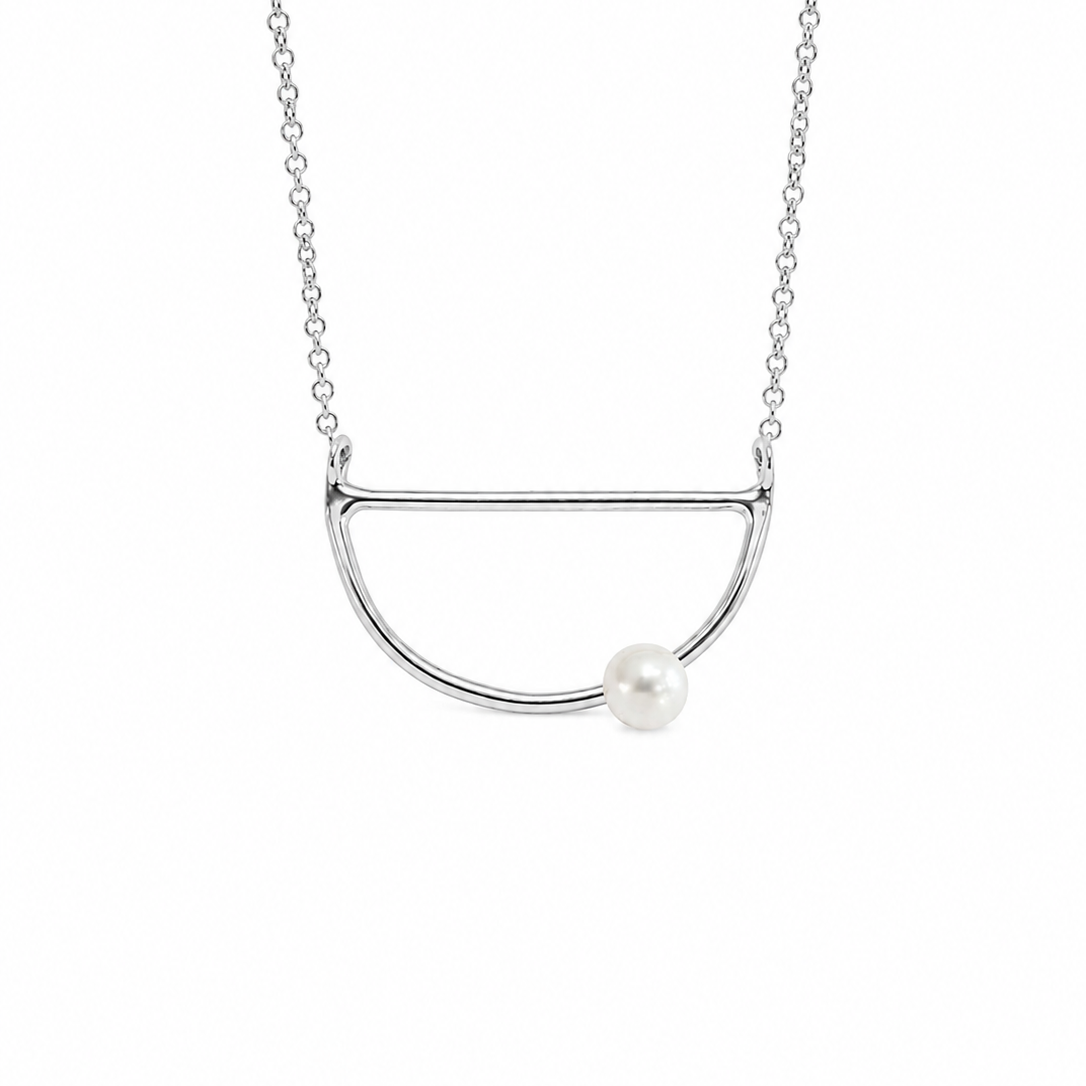 A silver necklace featuring a minimalist semi-circular open pendant with a single white pearl accent, suspended on a delicate silver chain against a plain white background.