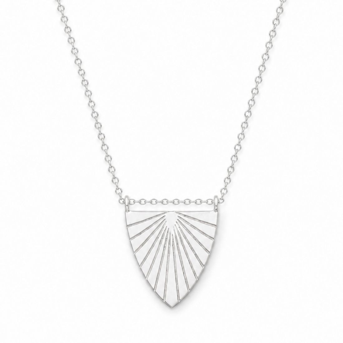 Silver necklace with a sunburst pendant on a white background