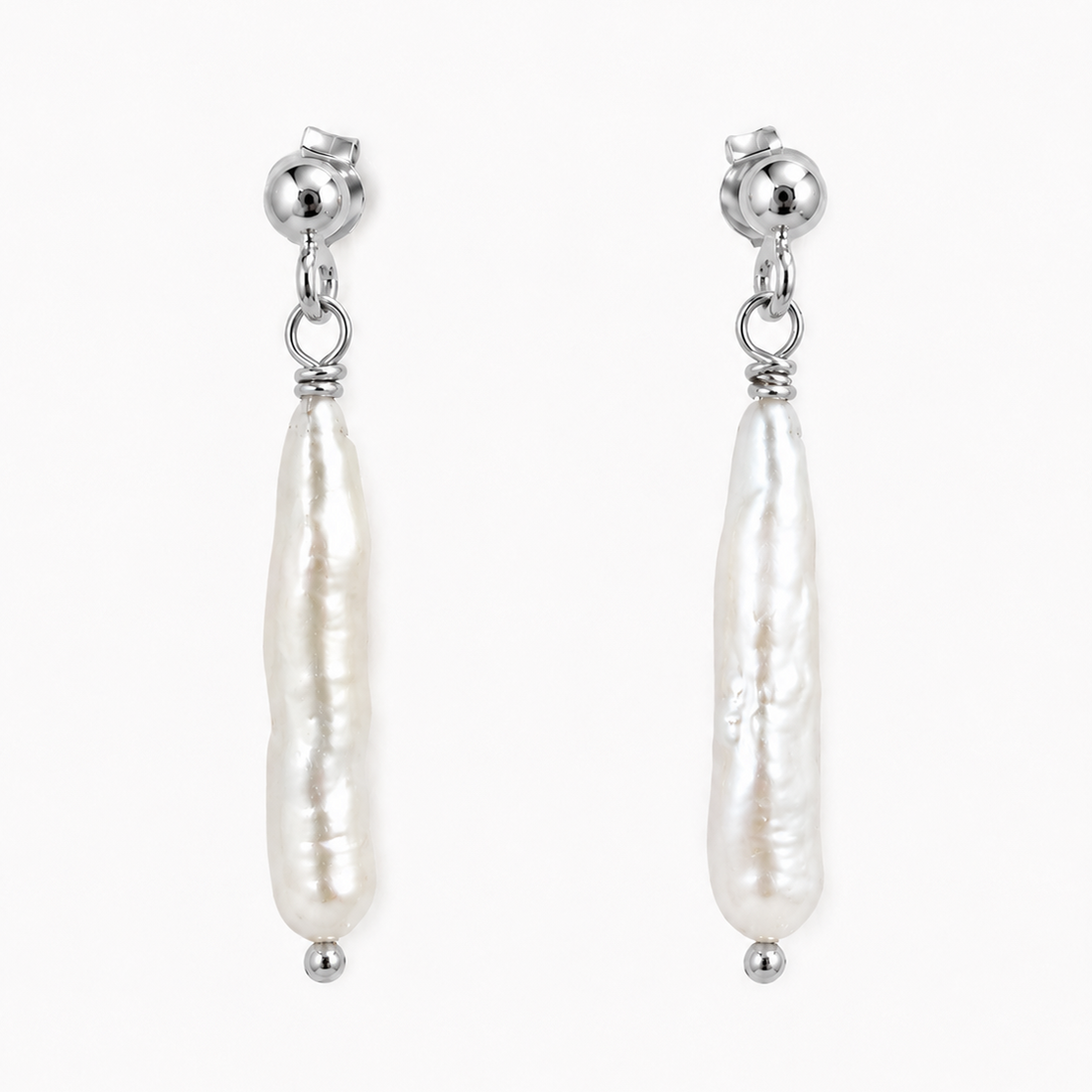 Gold earrings with white pearls on a white background