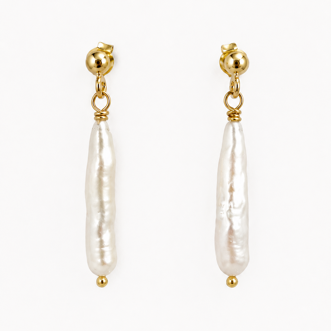Gold earrings with white pearls on a white background