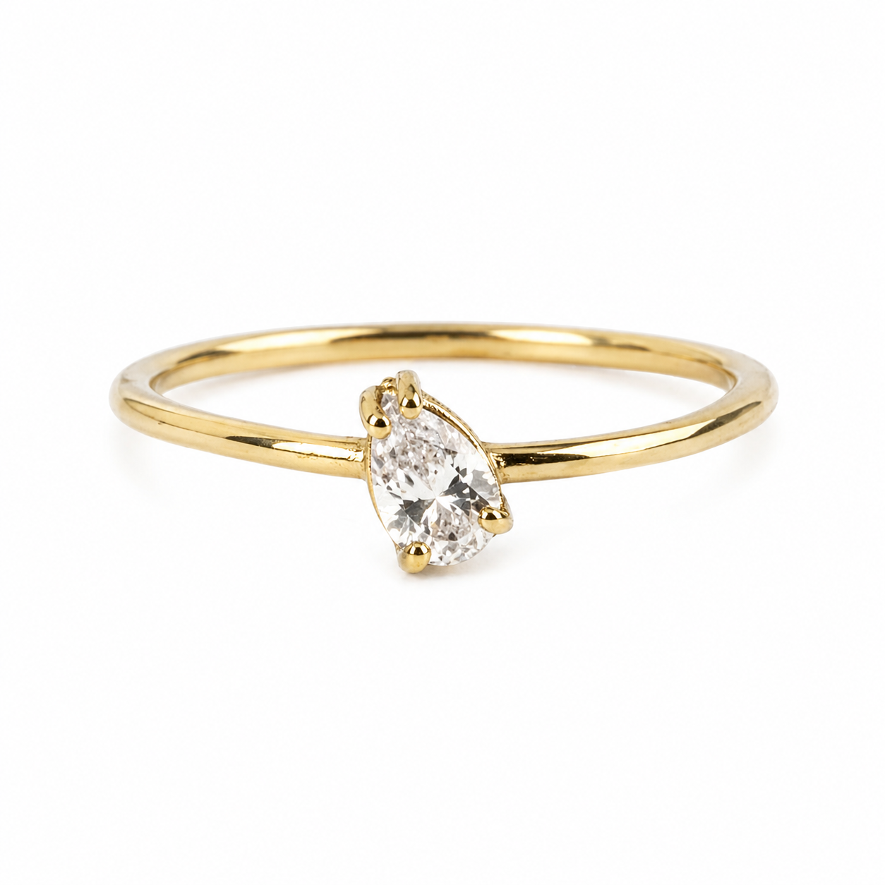 Gold ring with a pear-shaped diamond on a white background