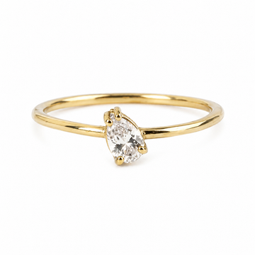 Gold ring with a pear-shaped diamond on a white background