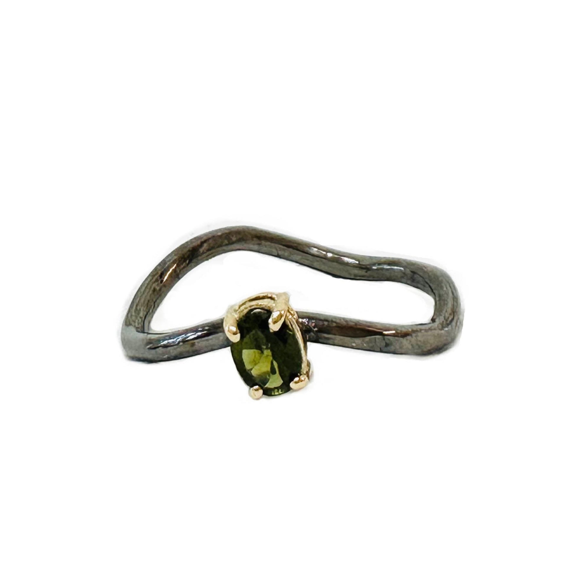 Ring with a green gemstone on a white background