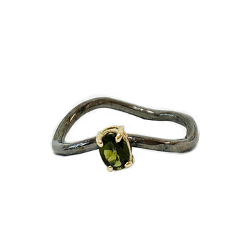 Ring with a green gemstone on a white background