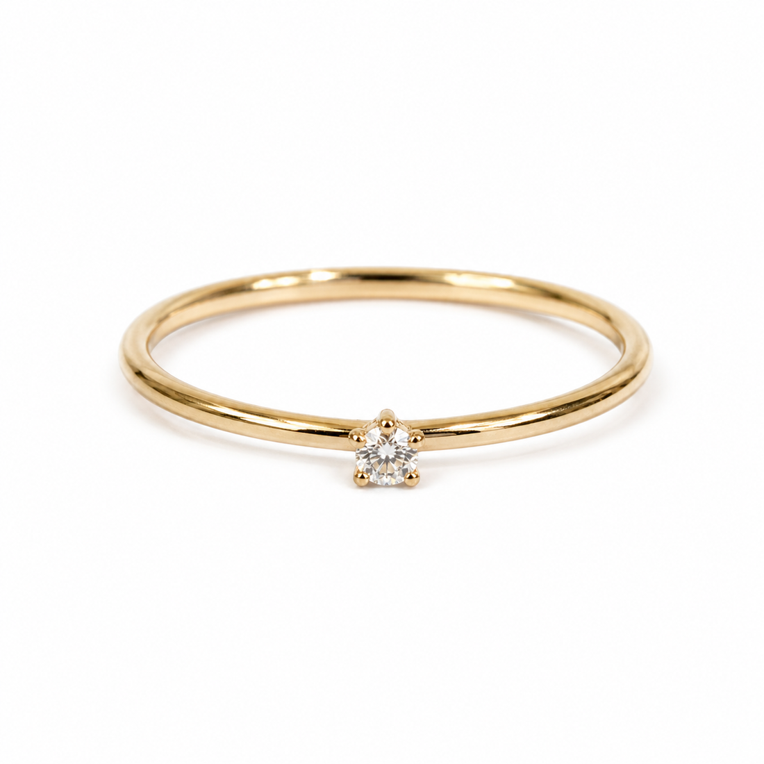 Gold ring with a tiny  diamond on a white background