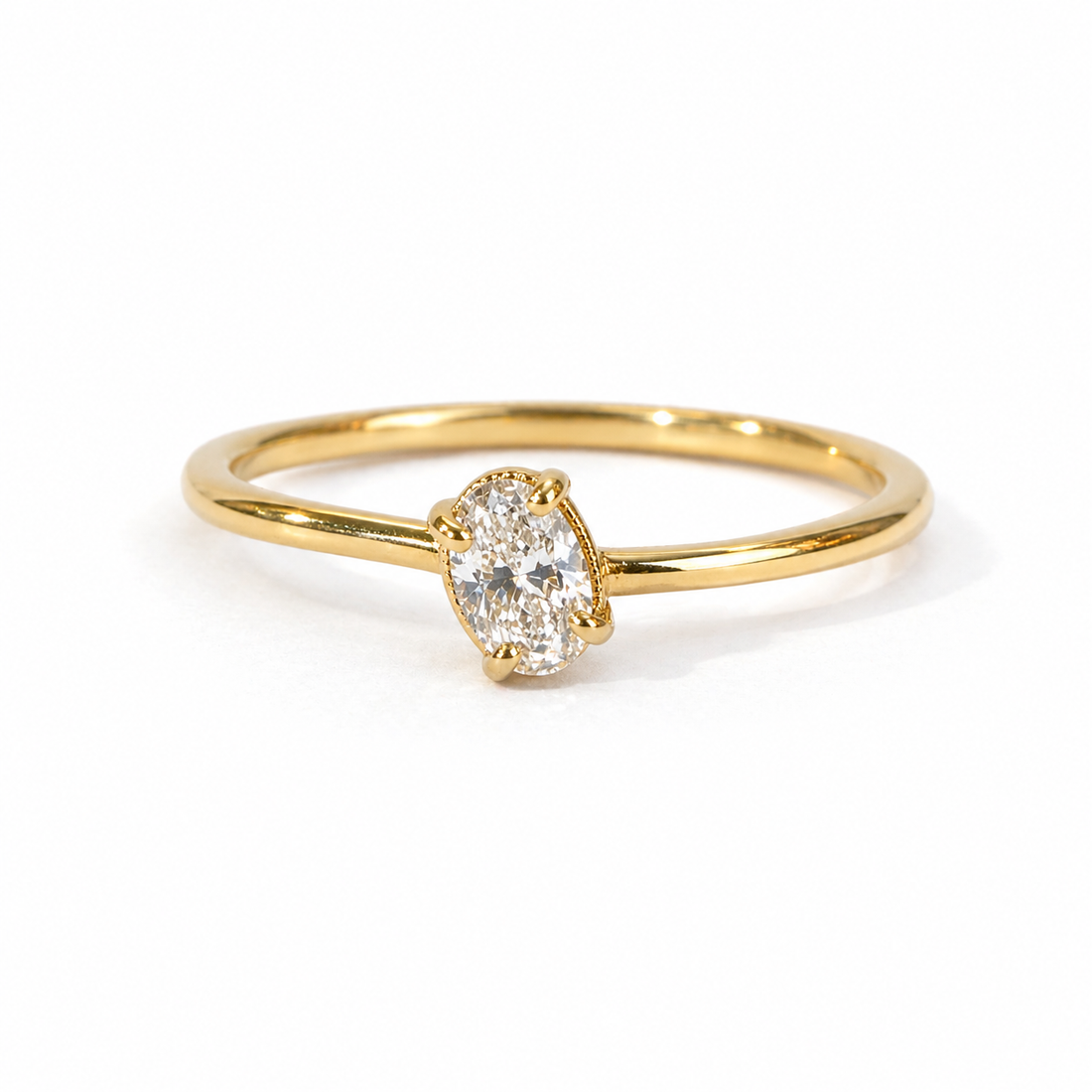 Gold ring with a diamond on a white background