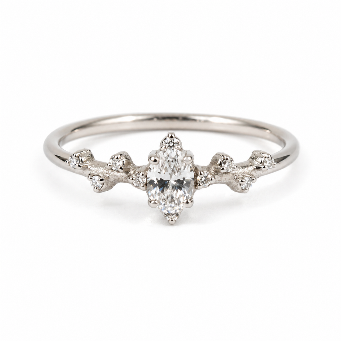 9k white gold  ring with a central diamond and smaller diamonds on a white background