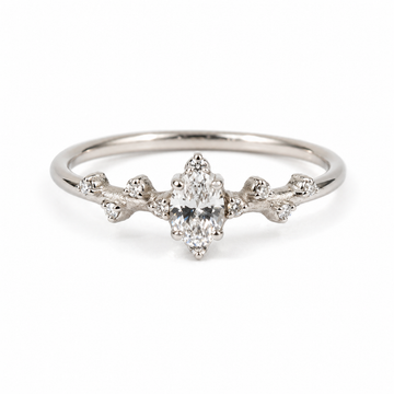 9k white gold  ring with a central diamond and smaller diamonds on a white background