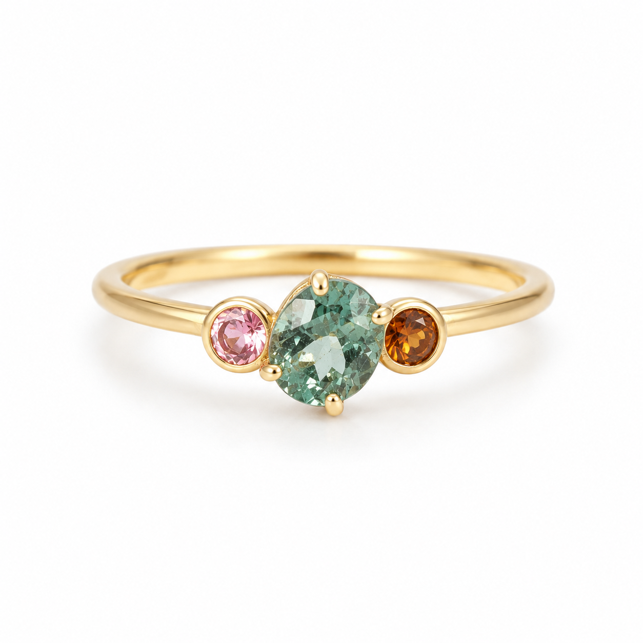 Gold ring with three colored gemstones on a white background