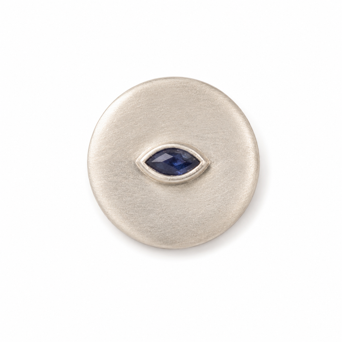 Silver circular ring with a blue gemstone on a white background