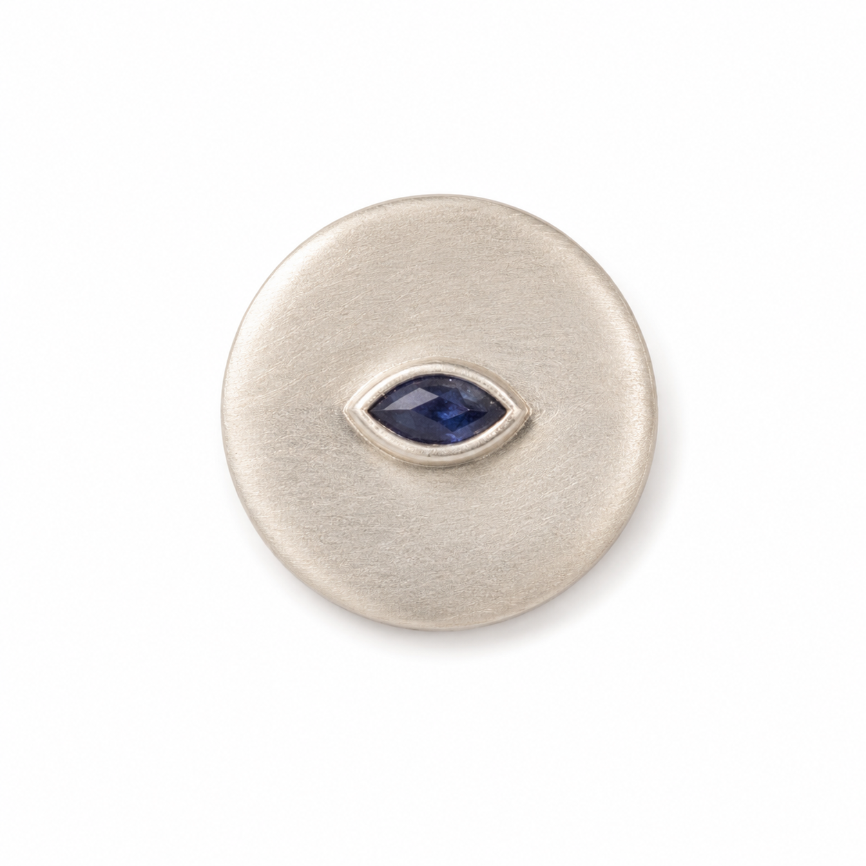 Silver circular ring with a blue gemstone on a white background