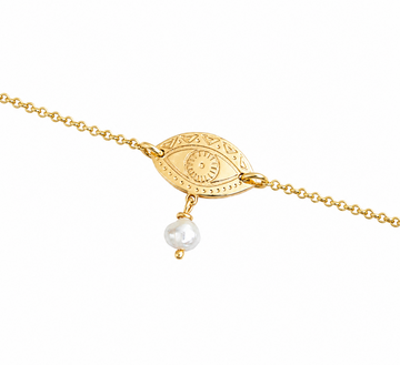 Gold-plated bracelet with an eye-shaped pendant and a pearl on a white background